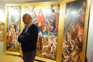 Herbert Perathoners 74-jähriger Bruder Bruno ist einer der bekanntesten Maler des Tals. Hier steht der Künstler vor einem Triptychon, an dem er sechs Jahre lang arbeitete. – Foto: Val Gardena-Gröden Marketing
