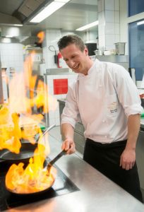 Spaß am Kochen - Chefkoch Maximilian Moser beim Flambieren in der Küche.